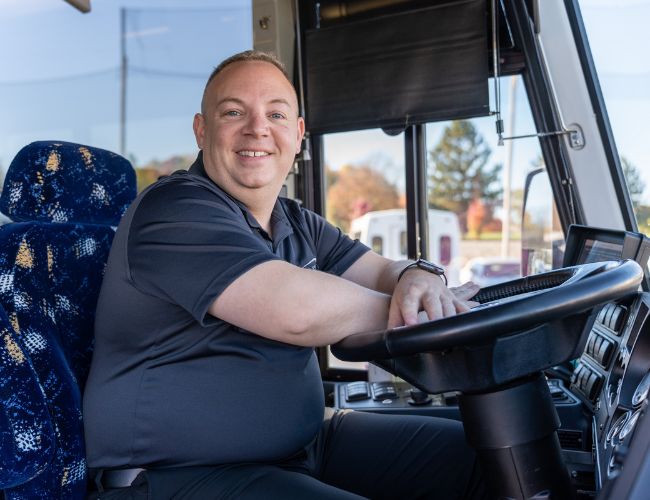 Man sitting at bus steering wheel