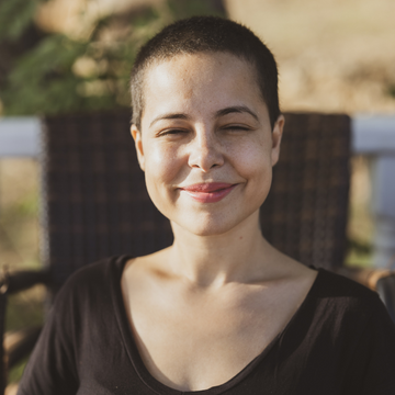 woman with buzz cut smiling at the camera