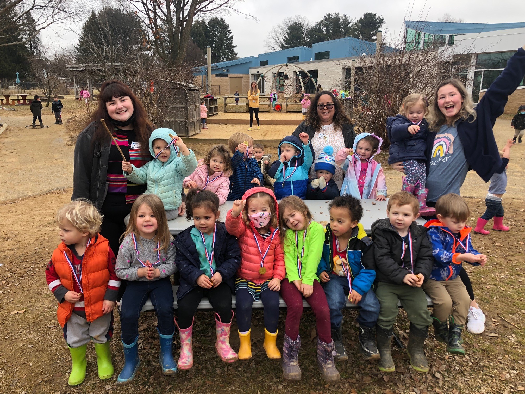 Children and Teachers smiling outside