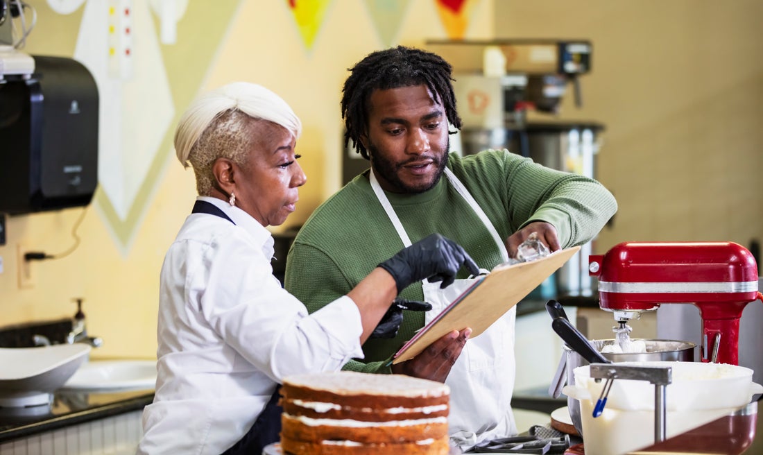 two people working at a bakery.