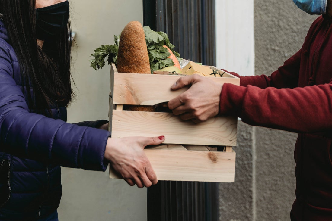 Someone handing food to another person.