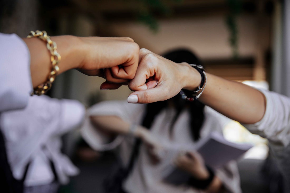 Women fist bumping.