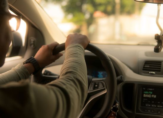 Person sitting in driver's seat of a car