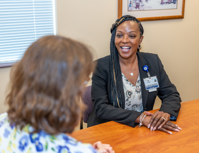 Women at conference table laughing