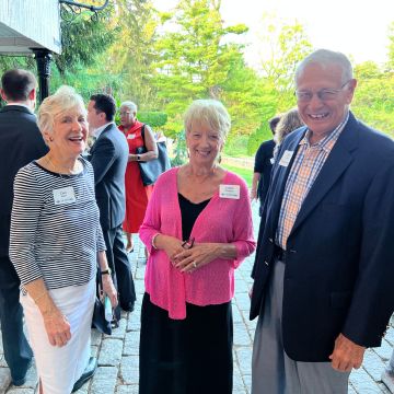 Three people talking and smiling