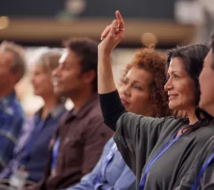 Woman raising her hand.