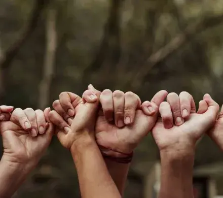 People holding hands together.