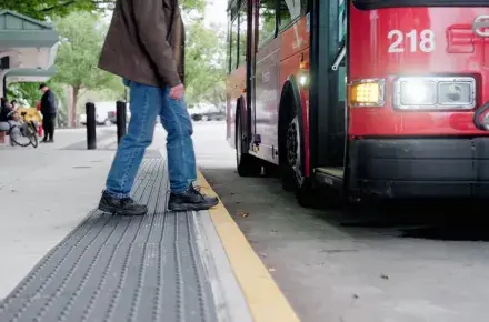 Man walking onto a bus.
