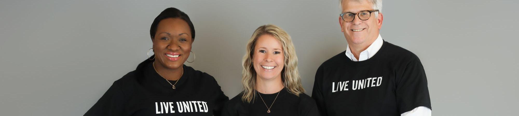 Three people smiling in LIVE UNITED shirts