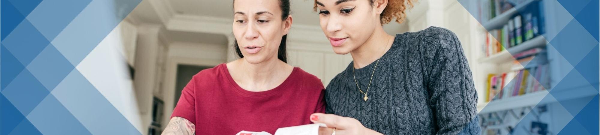 Two women pouring over tax receipts