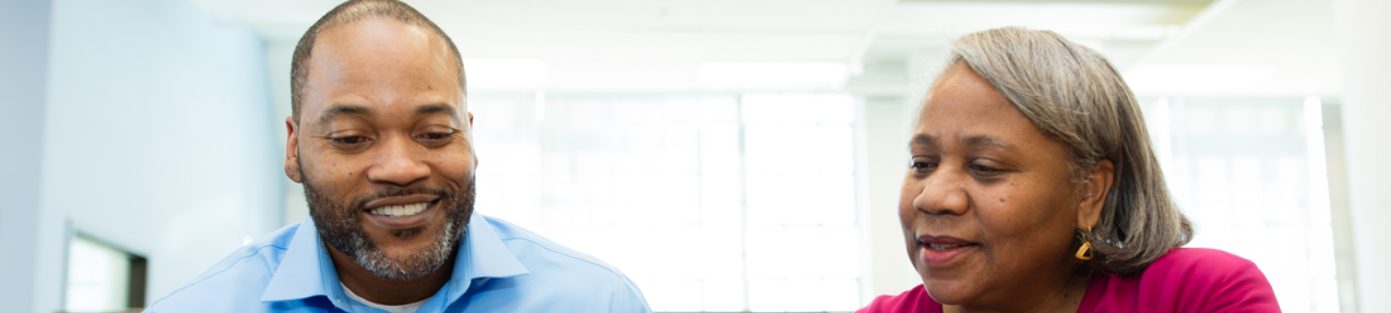 Man preparing his taxes with the help of a volunteer.