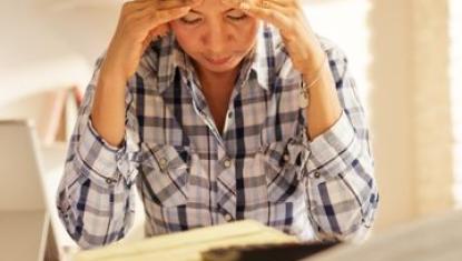 Woman stressed by paying bills