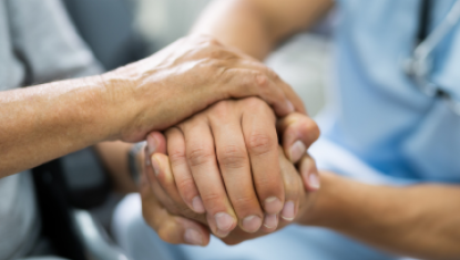 doctor and patient holding hands