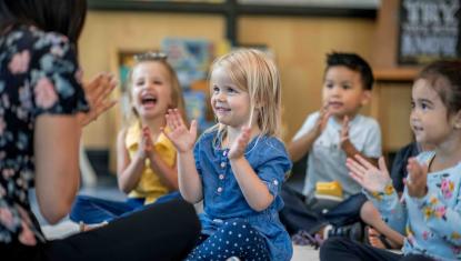Children sitting in childcare room.