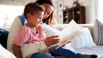 Mom reading to her son.