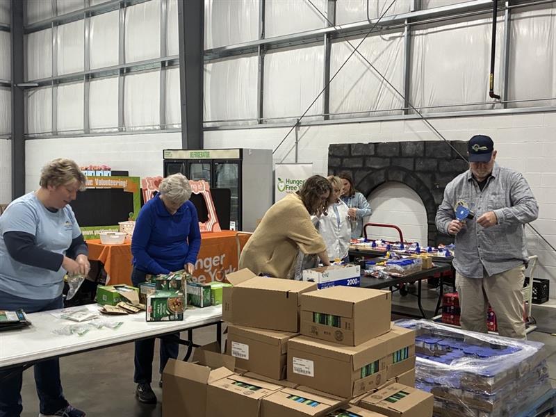 Volunteers packing boxes.
