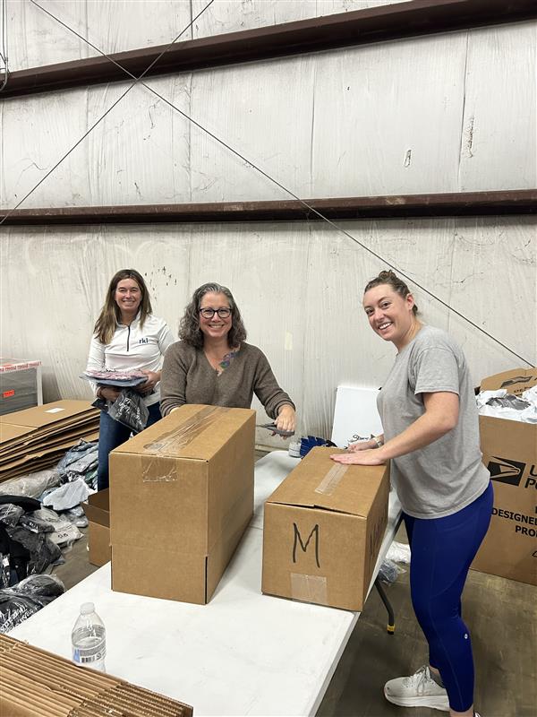 Volunteers at Maple Press packing boxes.