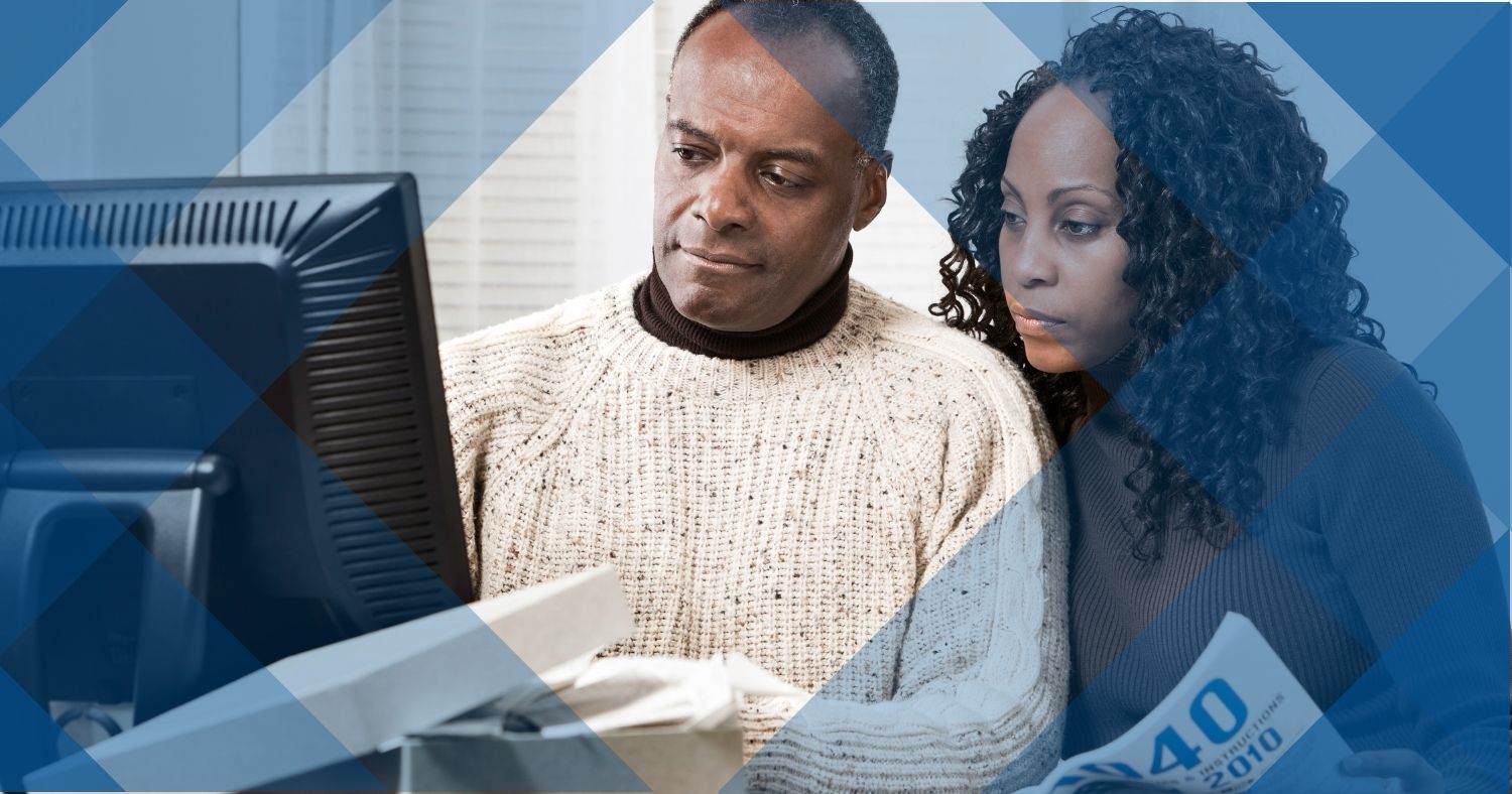 couple looking stressed while filing taxes