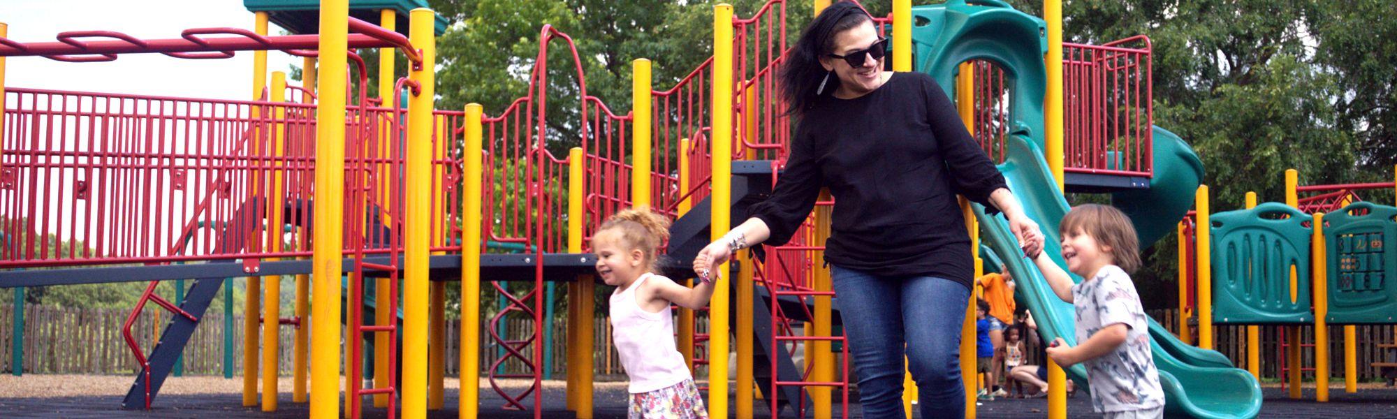 Woman and her kids playing in the park.