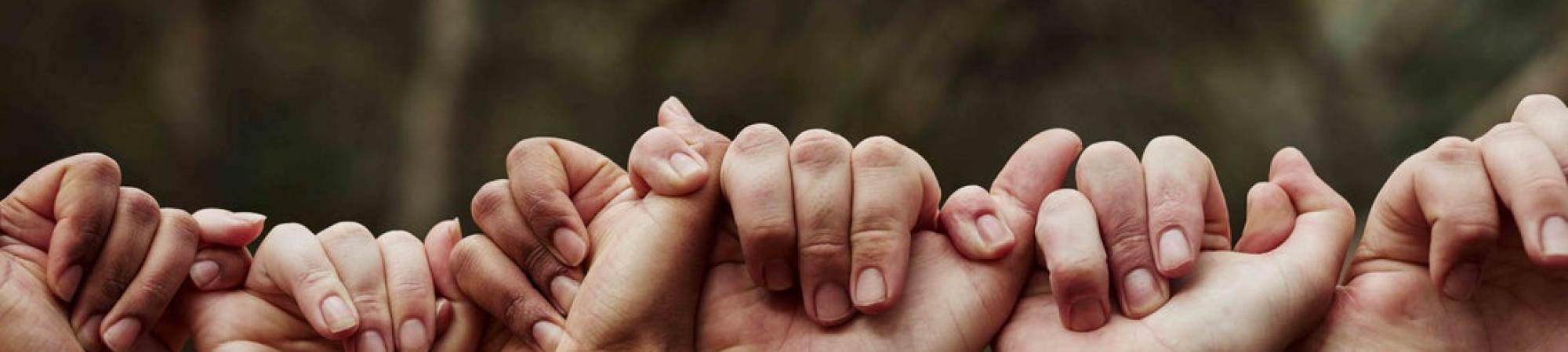 People holding hands together.