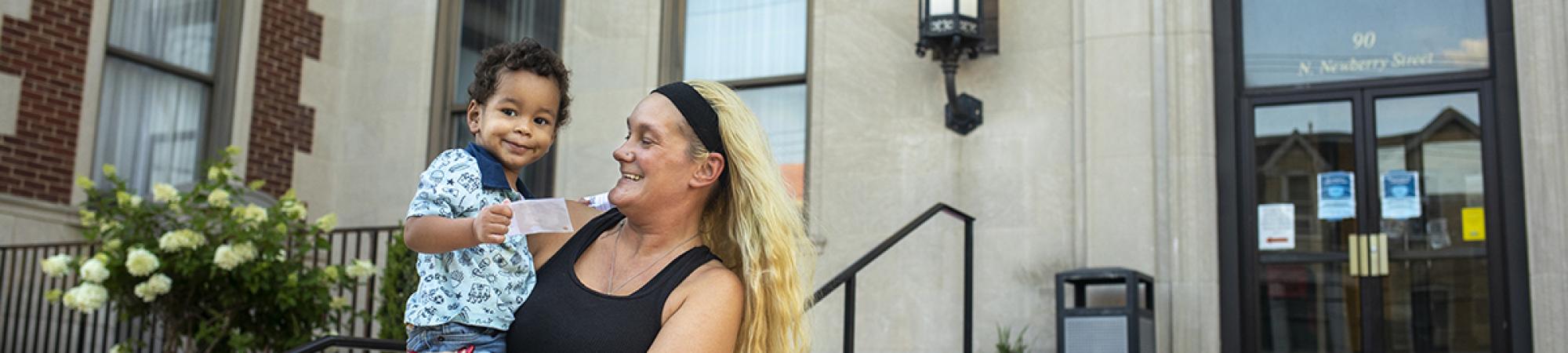 Woman holding young child